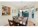 Charming dining room with hardwood floors, a large wooden table, and windows overlooking the landscaped yard at 102 Treadwell Ct, Cary, NC 27513
