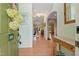 Inviting entryway with wood floors, a decorative table, and an arched doorway leading to the living spaces at 102 Treadwell Ct, Cary, NC 27513