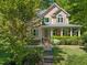 A charming two-story home with a cozy front porch and beautiful landscaping, creating a welcoming entrance at 102 Treadwell Ct, Cary, NC 27513