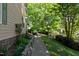 Well-maintained walkway along lush garden beds, leading to a beautiful home at 102 Treadwell Ct, Cary, NC 27513