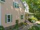 Two-story home with a covered front porch, beautiful windows, and lush greenery, offering a welcoming outdoor space at 102 Treadwell Ct, Cary, NC 27513