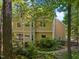 Rear exterior view of a two-story home featuring large windows and lush landscaping at 102 Treadwell Ct, Cary, NC 27513