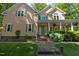 Charming two-story home with a covered front porch, brick pathway, and well-maintained landscaping at 102 Treadwell Ct, Cary, NC 27513