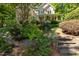 Stunning two-story home with a welcoming front porch, lush landscaping, and stone steps leading to the entrance at 102 Treadwell Ct, Cary, NC 27513