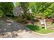 Charming home with lush landscaping and a stone retaining wall leading to the front entrance at 102 Treadwell Ct, Cary, NC 27513