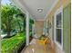 Covered front porch with charming details including hanging plants and rocking chairs at 102 Treadwell Ct, Cary, NC 27513