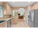 Spacious kitchen with light wood cabinets and stainless steel appliances with an open view to the living room at 102 Treadwell Ct, Cary, NC 27513