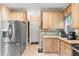 Functional kitchen featuring ample cabinetry, stainless steel refrigerator, and convenient access to the doorway at 102 Treadwell Ct, Cary, NC 27513