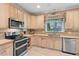 Bright kitchen featuring stainless steel appliances, ample counter space, and modern fixtures at 102 Treadwell Ct, Cary, NC 27513