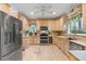 Well-lit kitchen with stainless steel appliances, light wood cabinets, and a window over the sink at 102 Treadwell Ct, Cary, NC 27513