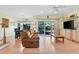 Living room with an open floor plan, hardwood floors, a sliding glass door to the backyard, and comfortable seating at 102 Treadwell Ct, Cary, NC 27513