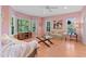 Bright and airy living room with pink walls, hardwood floors, large windows, and comfortable seating at 102 Treadwell Ct, Cary, NC 27513