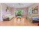 Bright and airy living room with pink walls, hardwood floors, large windows, and comfortable seating at 102 Treadwell Ct, Cary, NC 27513