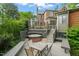Backyard deck features an outdoor dining table, hot tub, and multiple seating areas at 1024 W Markham Ave, Durham, NC 27701