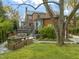 Backyard with a wooden deck, flower beds, and lush greenery surrounding the property at 1024 W Markham Ave, Durham, NC 27701