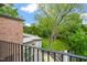 Balcony view overlooking the well-manicured lawn and mature trees at 1024 W Markham Ave, Durham, NC 27701