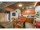 Basement area with a dining table, kitchenette, and unique ceiling design at 1024 W Markham Ave, Durham, NC 27701