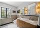 Modern bathroom with dual sinks, gold fixtures, and large window at 1024 W Markham Ave, Durham, NC 27701