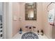 Powder room featuring unique vessel sink, modern faucet, and decorative mirror at 1024 W Markham Ave, Durham, NC 27701