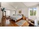 Bright bedroom features a wooden bed frame, hardwood floors, and a neutral color palette at 1024 W Markham Ave, Durham, NC 27701