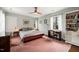 Bedroom with ceiling fan, desk, and bookshelf, offering a cozy retreat at 1024 W Markham Ave, Durham, NC 27701