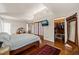 Spacious bedroom with a vaulted ceiling, hardwood floors, closet, and built-in shelving at 1024 W Markham Ave, Durham, NC 27701