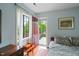 Cozy bedroom featuring hardwood floors and a door to a private balcony at 1024 W Markham Ave, Durham, NC 27701