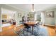Traditional dining room with hardwood floors, modern chandelier, and decorative rug at 1024 W Markham Ave, Durham, NC 27701