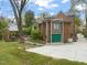 Exterior view showcasing a two-story home with a garage and lush landscaping at 1024 W Markham Ave, Durham, NC 27701