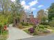 Charming brick home with well-manicured garden and driveway leading to the entrance at 1024 W Markham Ave, Durham, NC 27701