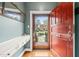 Inviting foyer with red front door, hardwood floors, mirror and white console offering a warm greeting into the home at 1024 W Markham Ave, Durham, NC 27701