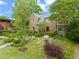 Beautiful brick home with lush front yard landscaping and a charming bench at 1024 W Markham Ave, Durham, NC 27701