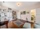 Spacious living room with hardwood floors, custom bookshelves, and a cozy seating area at 1024 W Markham Ave, Durham, NC 27701
