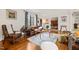 Comfortable living room featuring a leather sofa, hardwood floors, area rug, and a large window with draperies at 1024 W Markham Ave, Durham, NC 27701