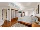 Serene main bedroom featuring hardwood floors, skylight, sliding closet doors, and an ensuite bathroom at 1024 W Markham Ave, Durham, NC 27701