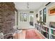 Bright office space featuring brick walls, built-in shelving, and a view of the outdoors at 1024 W Markham Ave, Durham, NC 27701
