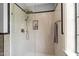 Beautiful tiled shower with bronze fixtures and dark trim in a luxurious bathroom at 1024 W Markham Ave, Durham, NC 27701