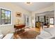 Bright sitting room with hardwood floors, a large window with black grids, and doorway to the living room at 1024 W Markham Ave, Durham, NC 27701