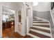 Staircase with wood treads and white risers, view into kitchen with breakfast bar at 1024 W Markham Ave, Durham, NC 27701