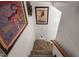 Staircase with carpeted steps and white walls adorned with framed art at 1024 W Markham Ave, Durham, NC 27701