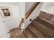 Staircase with carpeted steps and white walls and wooden handrail at 1024 W Markham Ave, Durham, NC 27701
