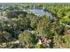 Aerial view of the homes features a lake and dense canopy of mature trees at 104 Silver Fox Ct, Cary, NC 27511