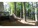The home's backyard features a wooden deck and steps leading to a yard with mature trees at 104 Silver Fox Ct, Cary, NC 27511