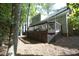 A view of the house's rear exterior showcases a wooden deck and mature trees at 104 Silver Fox Ct, Cary, NC 27511