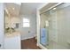 Bathroom with glass-enclosed shower, single sink vanity, and neutral color palette at 104 Silver Fox Ct, Cary, NC 27511