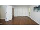 View of a light-filled bedroom with hardwood floors, white walls, and ample closet space at 104 Silver Fox Ct, Cary, NC 27511