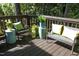 Close-up of a deck showing decorative accents, seating, and greenery in a wooded setting at 104 Silver Fox Ct, Cary, NC 27511