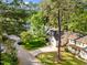 Aerial view features the home's roof, driveway, green lawn, and mature trees at 104 Silver Fox Ct, Cary, NC 27511