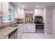 Bright and spacious kitchen with stainless steel appliances and light granite countertops at 104 Silver Fox Ct, Cary, NC 27511