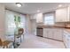 Cozy kitchen featuring white cabinets, granite countertops, and stainless-steel appliances at 104 Silver Fox Ct, Cary, NC 27511